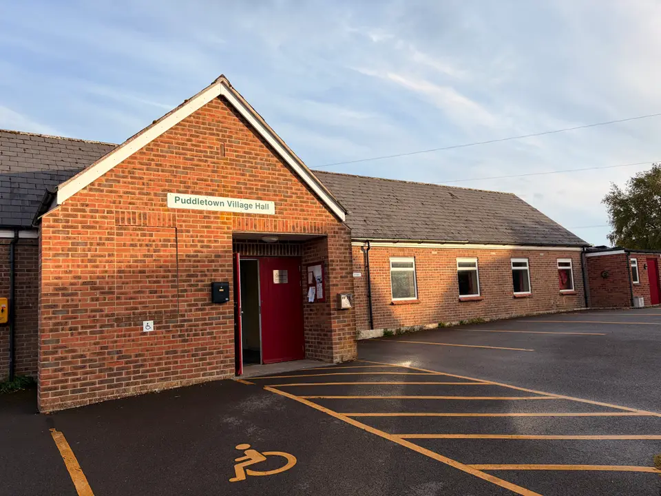 Outside the hall, with the car park and disabled parking space