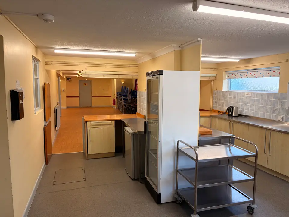 Kitchen with fridge freezer and serving trolley